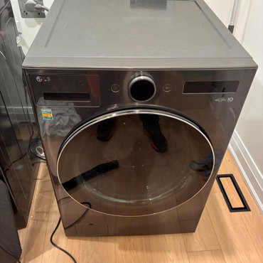 LG front-load washing machine in dark steel finish installed in an Ottawa laundry room